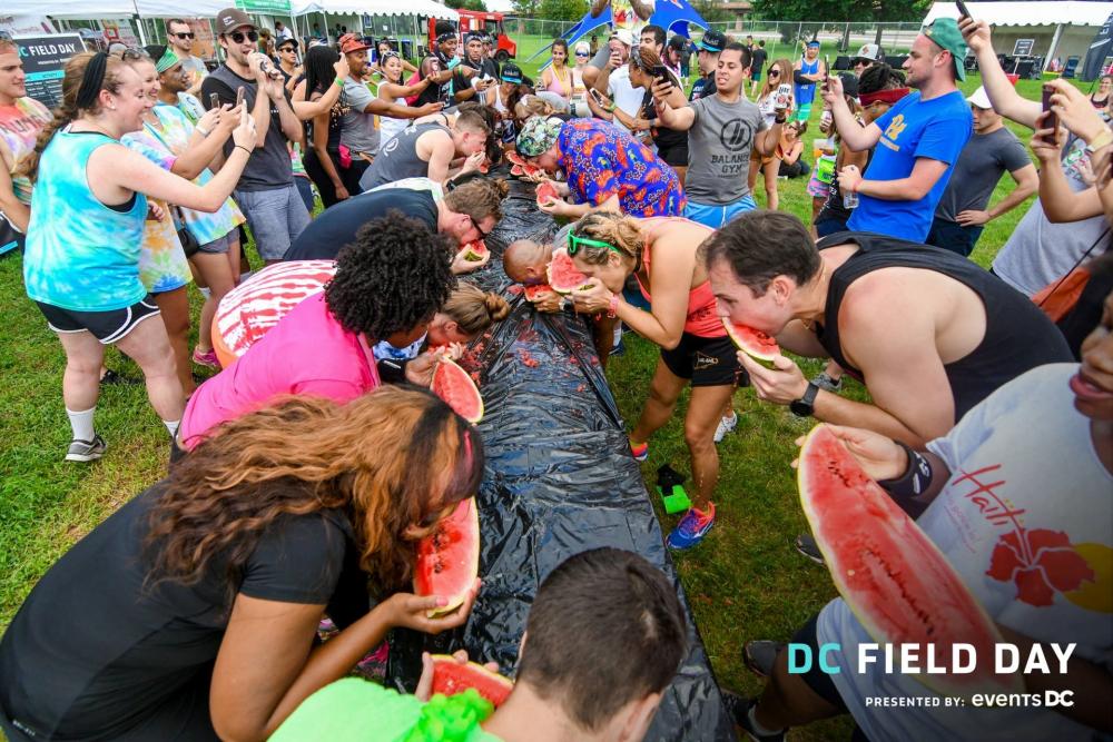 Field day attendees participating in an eating contest