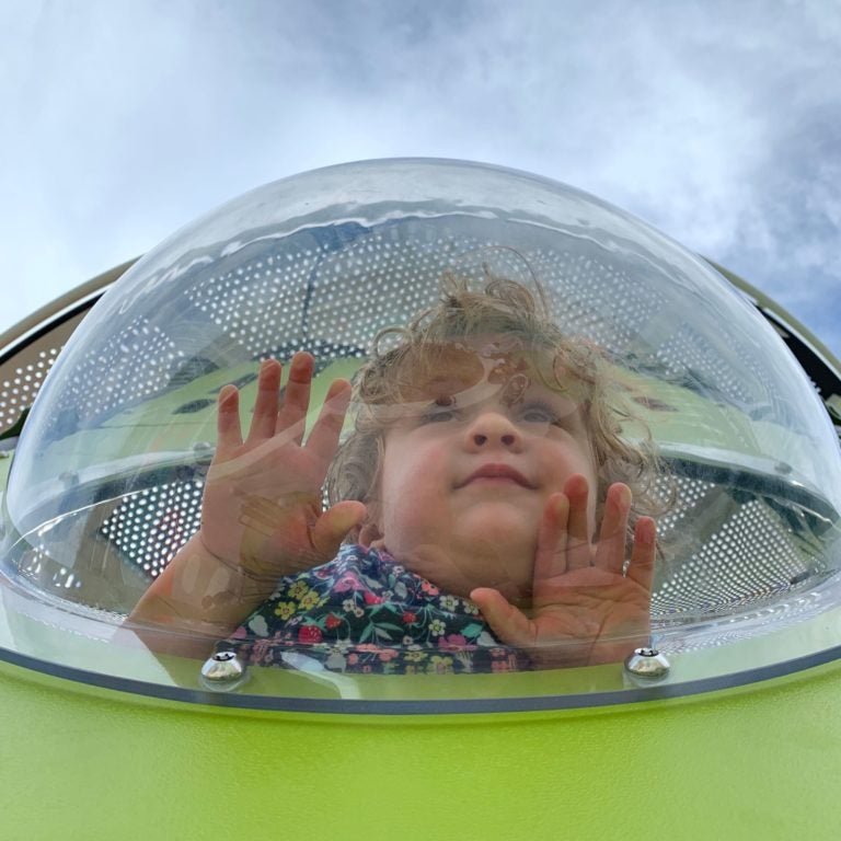 Child on a playground at The RFK Fields