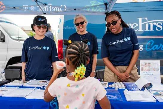 Volunteers assisting at the event booth