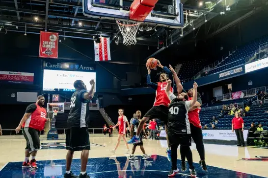 Players tackling in a basketball game
