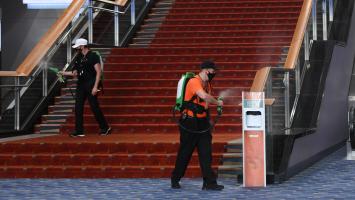 Electrostatic sprayers in use on stair handrail