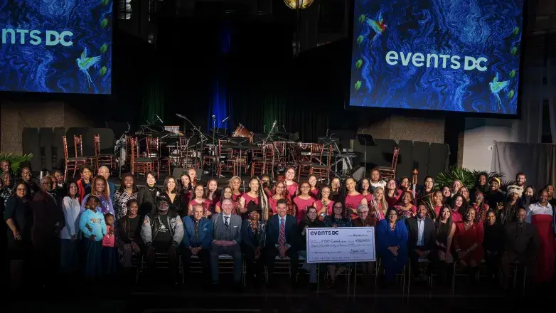 Events DC leadership and FY 2025 grantees pose with $750,000 check